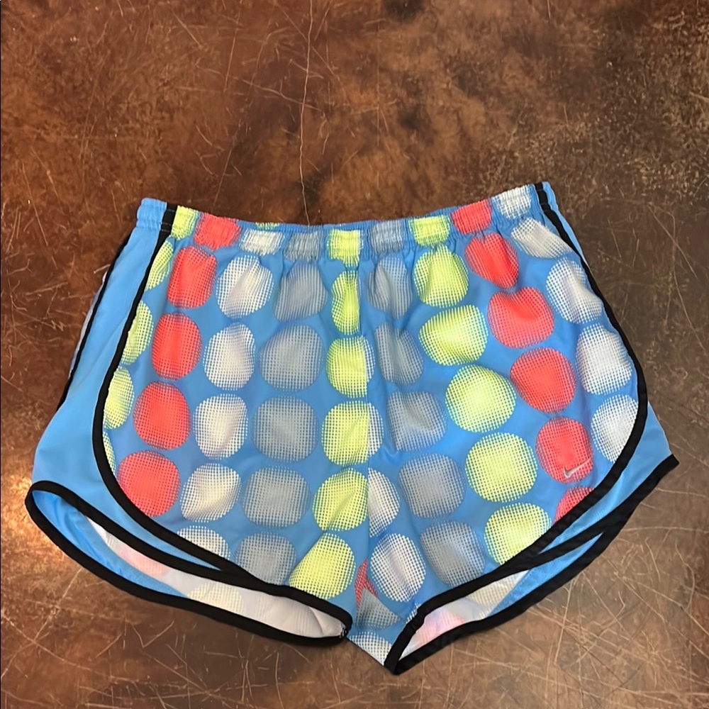 Women’s Nike running shorts blue with orange and yellow circles. Size Medium.